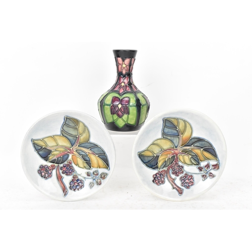 91 - Moorcroft pottery to include a pair of 'bramble' pattern pin dishes 11.5cm diameter and a 'violet' p... 