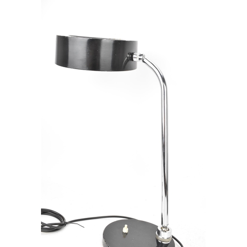 98 - A mid century modern desklamp, designed by André Mounique for French company Jumo, having a black en... 