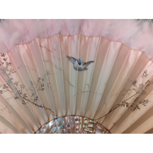 35 - Duvelleroy, Paris-A cream silk fan with pink hues having a hand-painted scene of a bird inflight bet... 