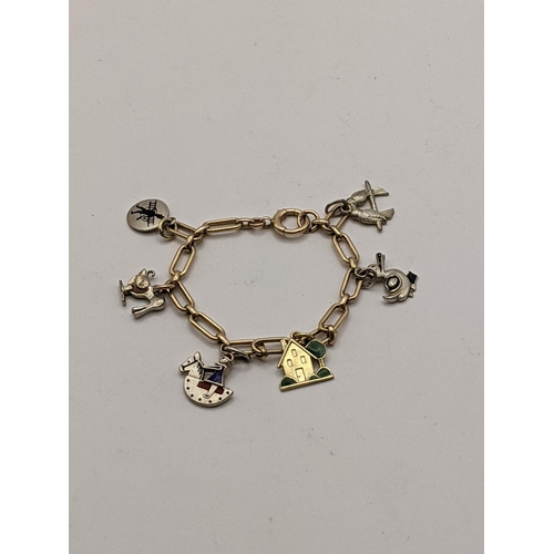 52 - **THIS LOT HAS BEEN WITHDRAWN**
A 9ct gold child's bracelet together with a 15ct gold charm in the f... 