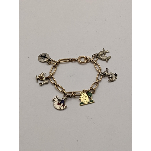 52 - **THIS LOT HAS BEEN WITHDRAWN**
A 9ct gold child's bracelet together with a 15ct gold charm in the f... 