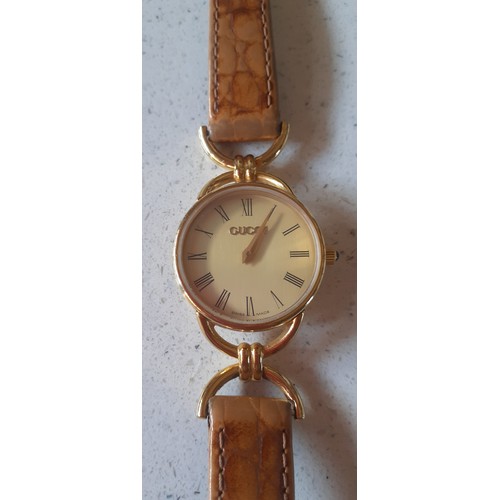 32 - Gucci- A 1990's ladies gold plated 6000.2.L watch with original mid brown Gucci leather strap. Locat... 