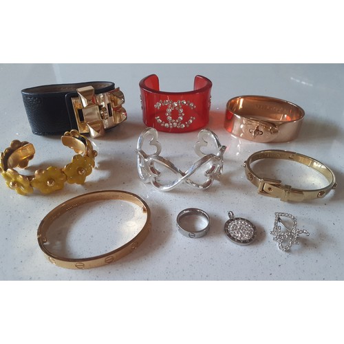 82 - A group of fashion bangles, a ring, brooch and pendant in the designer style together with a silver ... 