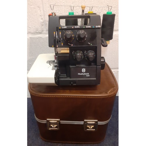 99 - A Husqvana Huskylock 530 sewing machine with case and accessories (plug requires adaptor for the UK ... 