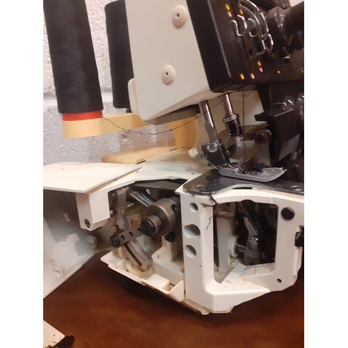 99 - A Husqvana Huskylock 530 sewing machine with case and accessories (plug requires adaptor for the UK ... 