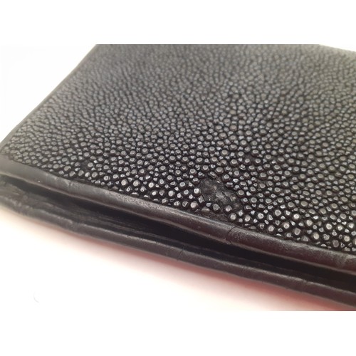 48 - A black polished stingray skin wallet with black leather interior. Location: BWR
If there is no cond... 