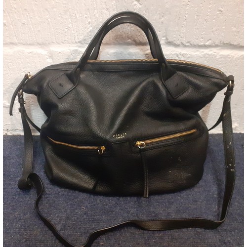 105 - A quantity of fashion bags to include a Guess canvas monogram holdall, a black Radley leather should... 