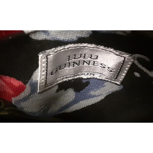 24 - Lulu Guinness- An embroidered black straw bag with floral cloth lining having a drawstring closure. ... 