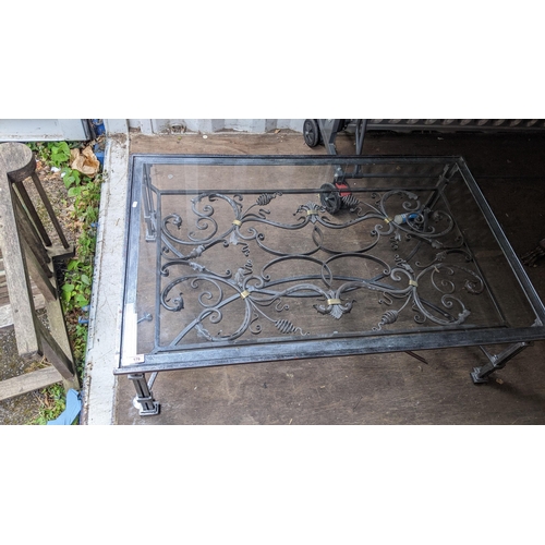 179 - A modern wrought metal coffee table with a glass top, 41cm h x 129cm w
Location: BCon
If there is no... 