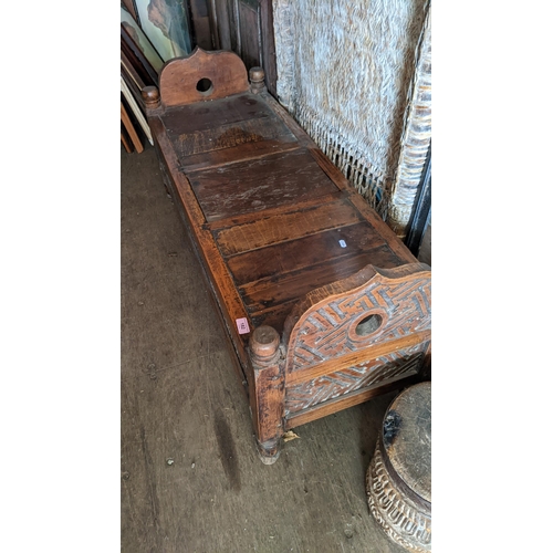 182 - A South Asian carved hardwood bench with a box base, on turned legs, 59cm h x 120cm w
Location: BCon... 