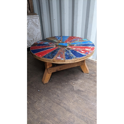 185 - A reconstituted painted wooden coffee table on teak legs, 46cm h x 90 dia
Location: BCon
If there is... 