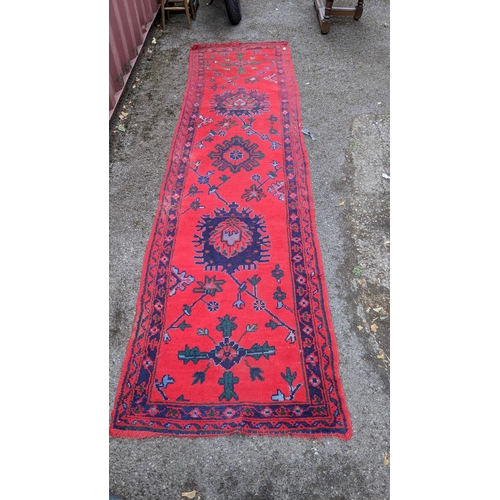 193 - A Turkish runner with geometric motifs on a red ground, 350cm l x 91cm w
Location: BB
If there is no... 