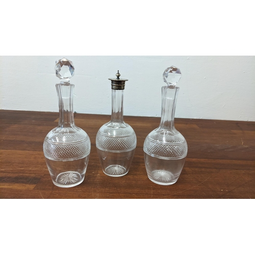 197 - Three early 20th century glass cruet bottles, each with start cut ornament
Location: 10-1
If there i... 