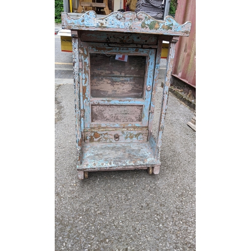 224 - An antique Indian painted shrine cabinet with a glazed wine panelled door with a canopy 77cm h x 49.... 