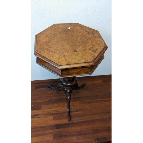 310 - A Victorian walnut sewing table with a hinged top enclosing a fitter interior on a tripod base
Locat... 