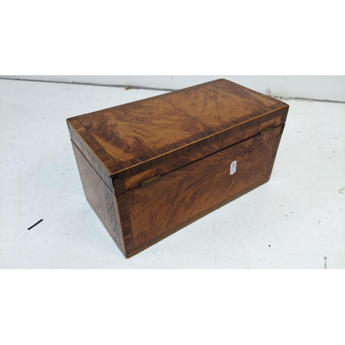 423 - An early 19th century mixed veneered tea caddy with marquetry ornaments
Location: BWR
If there is no... 