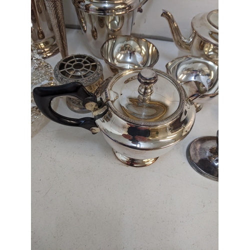 1 - Mixed silver plated items to include an ice bucket, 2 teapots, jug, a pair of candlestick holders, a... 