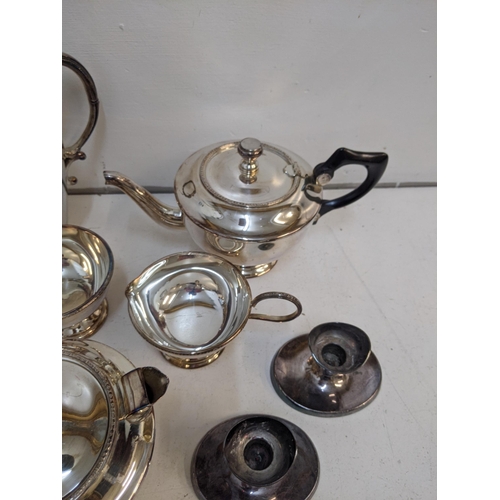 1 - Mixed silver plated items to include an ice bucket, 2 teapots, jug, a pair of candlestick holders, a... 