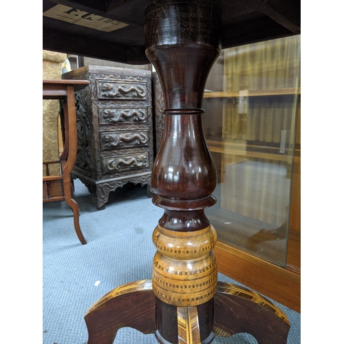 12 - A mid 19th century Italian side table with a marquetry top decorated with three flowers on a decorat... 