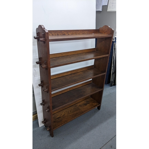 122 - An Arts & Crafts oak peg jointed five tier open bookcase, 123cm h x 90cm w
Location:A1F
If there is ... 