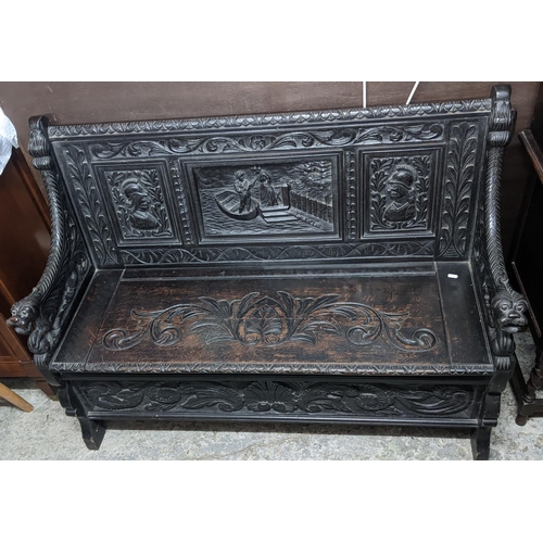 130 - A late 19th century oak carved bench, the panels carved with busts and a river scene of two figures,... 