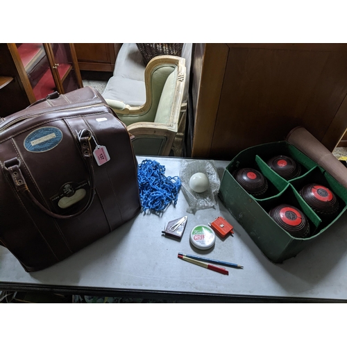 137 - A vintage leather holdall bag containing a sets of four Hemselite super grip championship lawn bowls... 