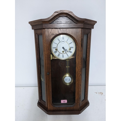 147 - A 20th century oak glazed regulator wall clock, white enamel dial with off set dial at 12 and three ... 