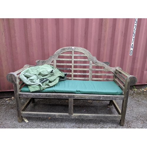 157 - A Lutyens weathered wooden slatted garden bench, with green upholstered cushion seat, with green fab... 