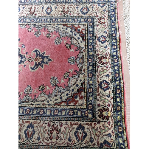 165 - A Kayson silk prayer rug, floral decoration on a red ground, multiguard borders and tasselled ends 1... 