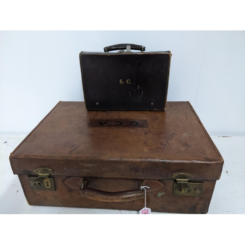 166 - A vintage leather travelling case with four silver topped glass bottles, London 1911, and other item... 