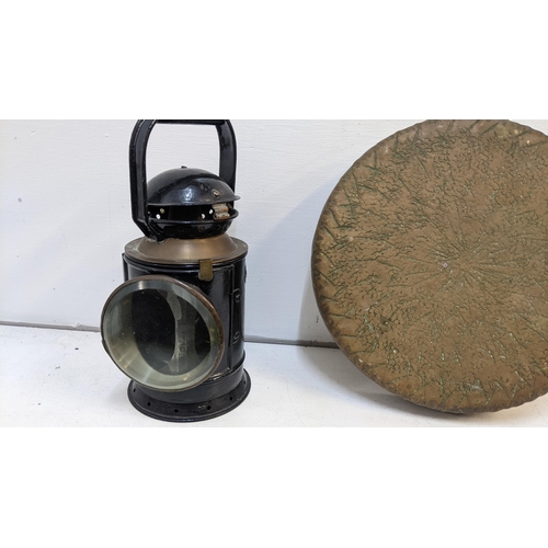 208 - An early 20th century dinner gong and a black painted and brass railway lantern A/F and two Asian bo... 