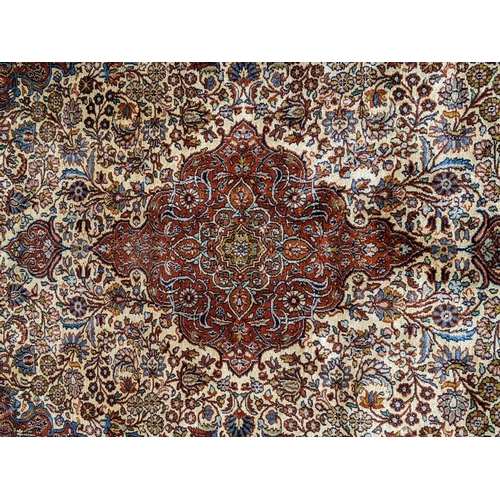 226 - A pure silk Persian Kashan rug with a central emblem decorated with a symmetrical abstract design wi... 