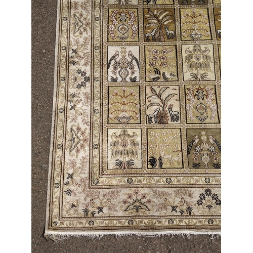 227 - A silk Turkish Hereke rug, the garden design, depicting different symbols and emblems in a 5x8 grid,... 