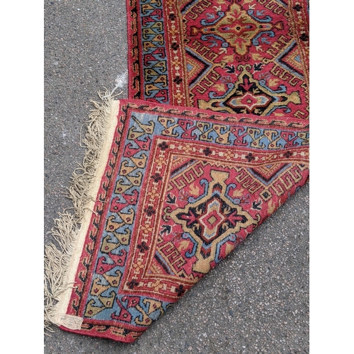 228 - A wool Eastern Turkestan Kashquai runner with eleven repeated central medallions five of one design ... 