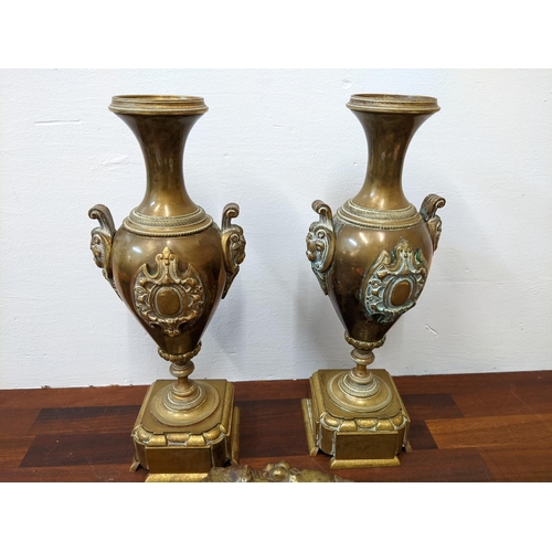 278 - A pair of brass 19th century candlesticks fashioned as arms, as a brass dish fashioned as a grapevin... 