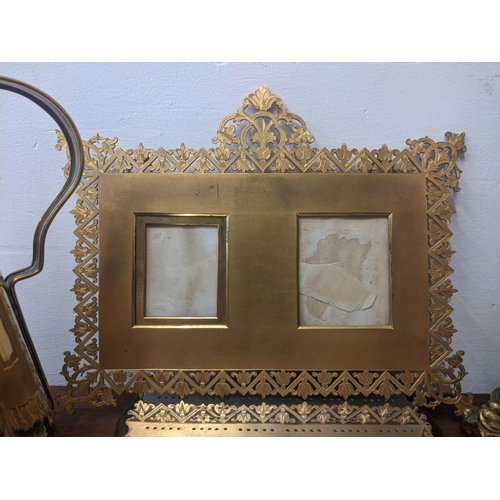 319 - Mixed items to include three candlesticks, a gold coloured ornate and pierced double photo frame and... 