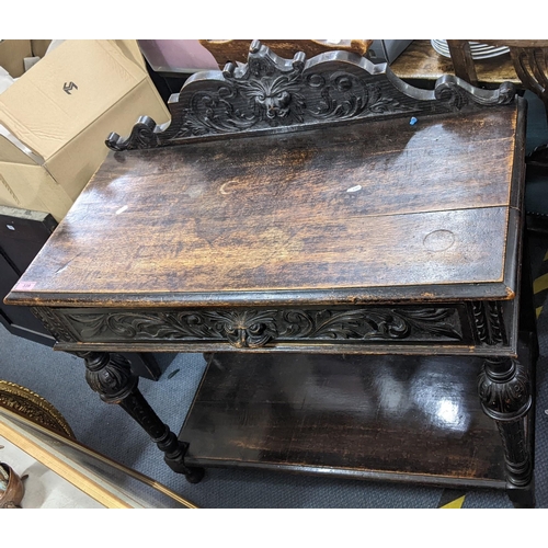 339 - A late Victorian pussy oak carved side table, having raised back, single shelf, baluster columns and... 