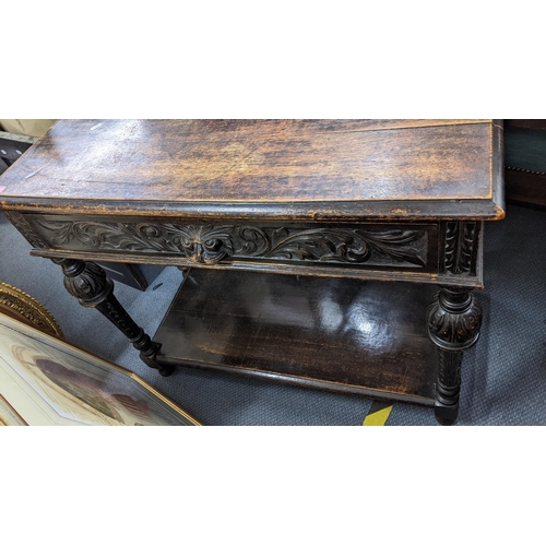 339 - A late Victorian pussy oak carved side table, having raised back, single shelf, baluster columns and... 