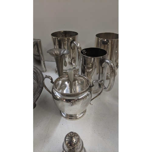 354 - A collection of mixed silver plated items to include tankards, cutlery and flatware, along with a mi... 