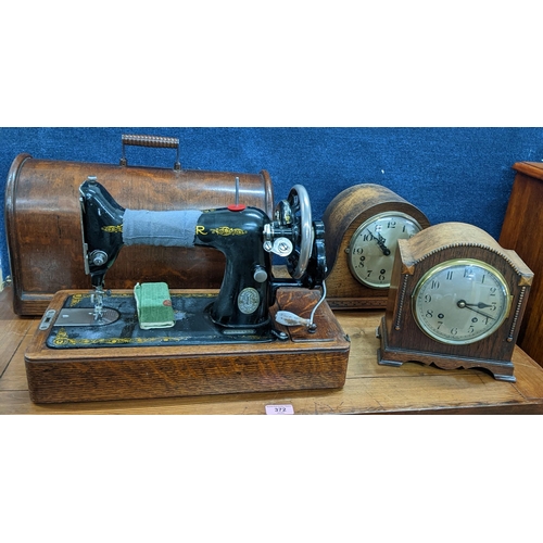 373 - Two early 20th century oak cased mantel clock and a Singer sewing machine
Location: A4M/A4B
If there... 