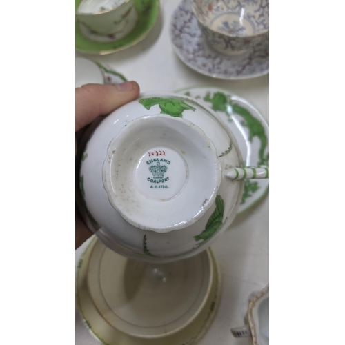 385 - A mixed lot of Victorian and later cups and saucers to include a Coalport cup and saucer decorated w... 