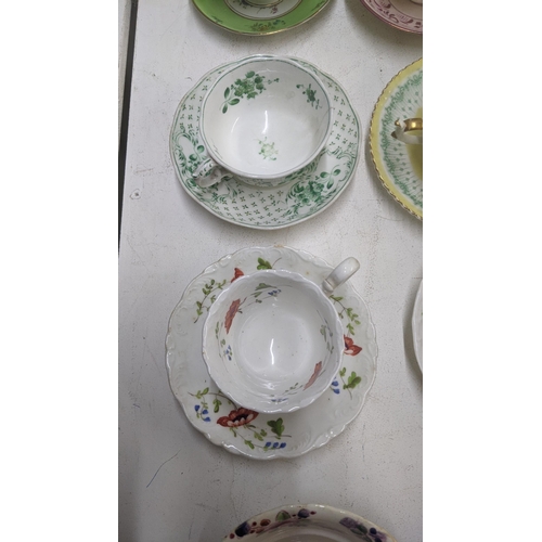 385 - A mixed lot of Victorian and later cups and saucers to include a Coalport cup and saucer decorated w... 