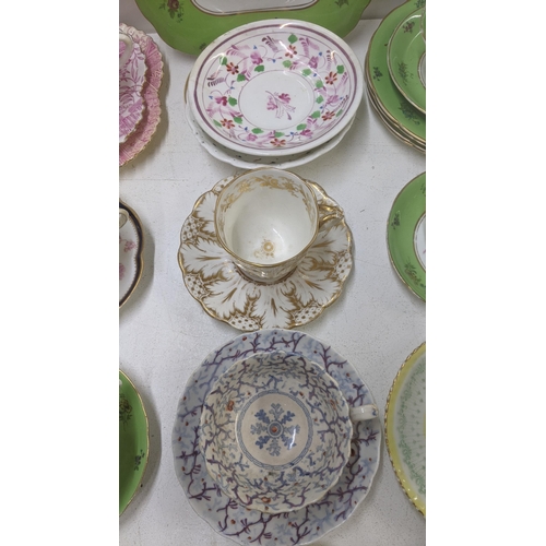 385 - A mixed lot of Victorian and later cups and saucers to include a Coalport cup and saucer decorated w... 