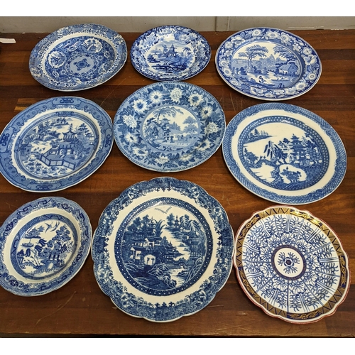 42 - A collection of blue and white patterned plates and dishes to include a Wedgwood example featuring a... 