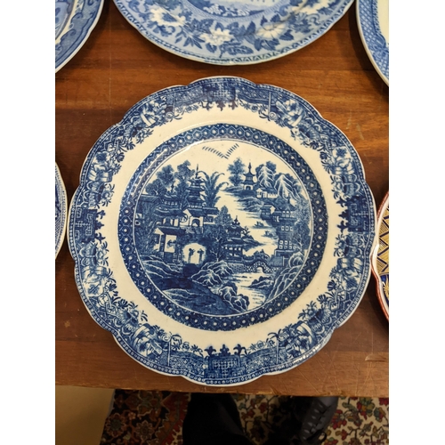 42 - A collection of blue and white patterned plates and dishes to include a Wedgwood example featuring a... 