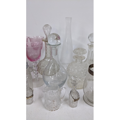 424 - Mixed glassware to include decanters, two late Victorian silver rimmed hurricane glasses and others
... 