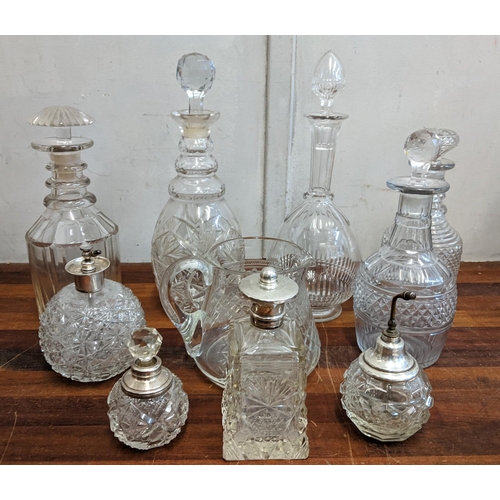 44 - A collection of crystal cut glass decanters, four scent bottles and a glass jug
Location:4.3
If ther... 