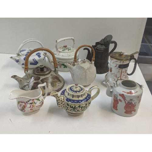 492 - Victorian and later tea pots to include a Iznik tea pot, an Oriental tea pot, a Yak butter tea pot a... 