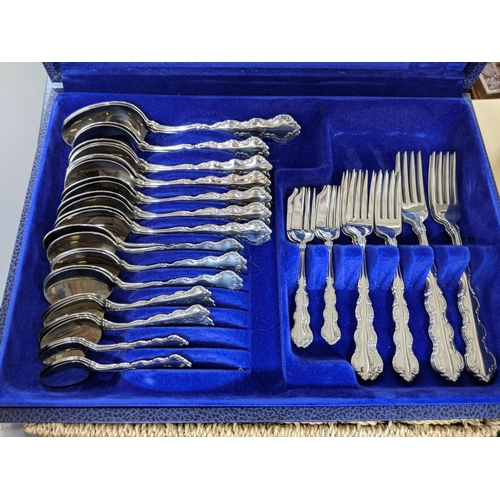 56 - An Oneida stainless steel canteen of cutlery comprising knives, forks, spoons, teaspoons and cake fo... 