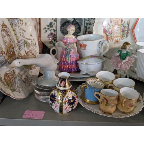 92 - A mixed lot of china and ceramics to include commemorative ware, a Lladro model, two Nao figures and... 